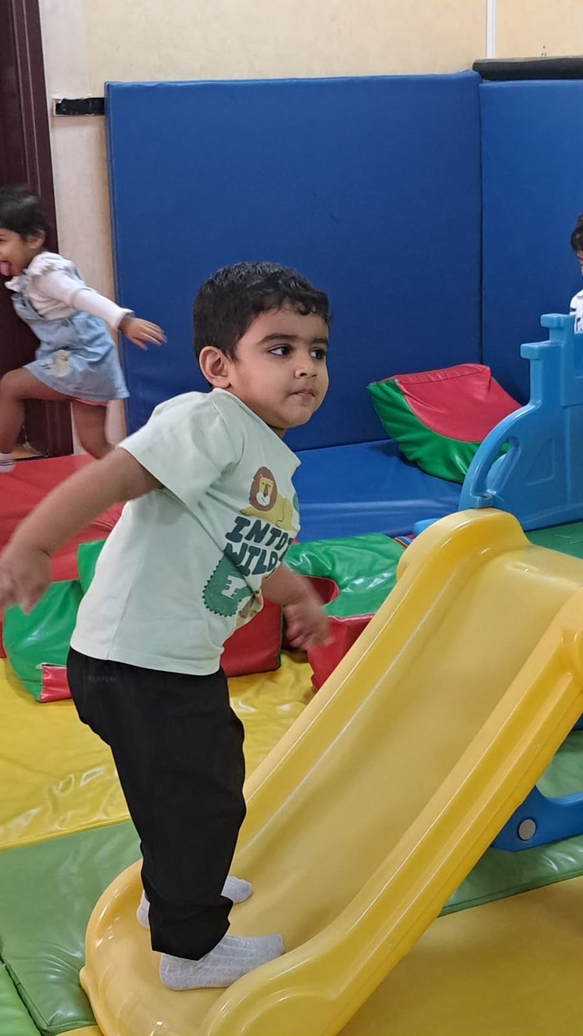 A child having fun down the indoor soft-play slide