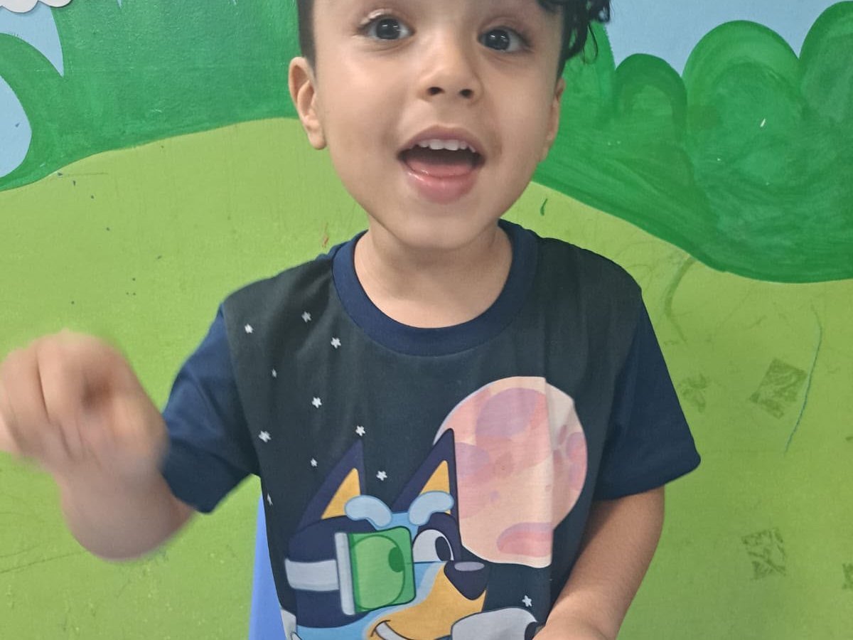 A cheerful child taking part in a hands-on craft activity
