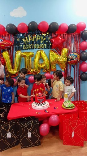 Celebrating a birthday with balloons and cake